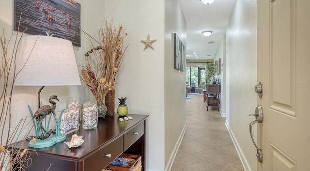 hall featuring light tile patterned flooring