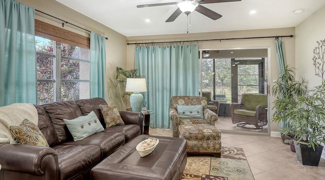 tiled living room with ceiling fan and plenty of natural light