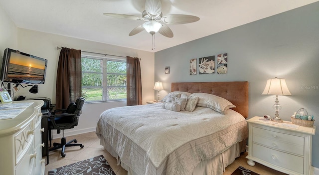 tiled bedroom featuring ceiling fan