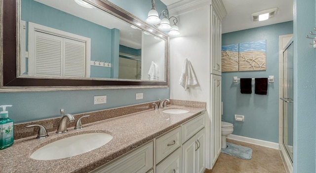 bathroom featuring tile patterned floors, vanity, toilet, and walk in shower