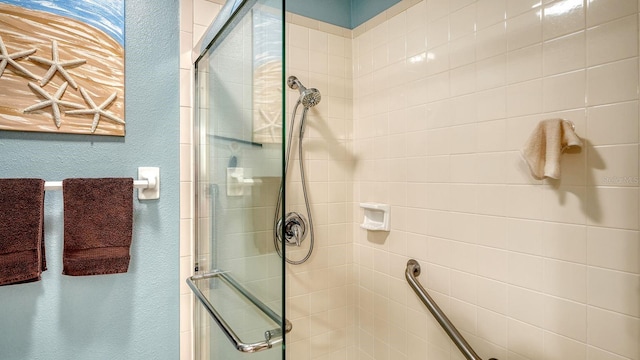 bathroom featuring a shower with shower door