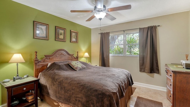 bedroom with ceiling fan and light tile patterned flooring