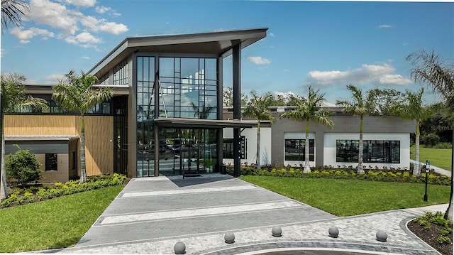 exterior space featuring a front lawn and a gate