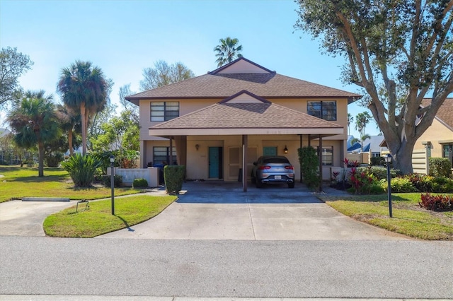 view of front of property with a front lawn and a carport