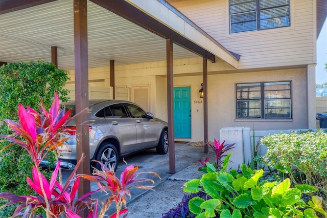 view of exterior entry featuring a carport