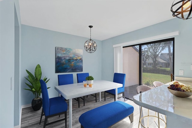 dining area featuring hardwood / wood-style floors and a chandelier