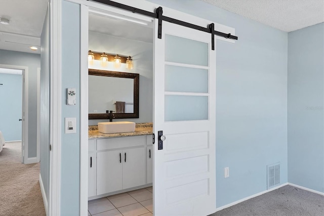 bathroom with vanity, tile patterned flooring, and a textured ceiling