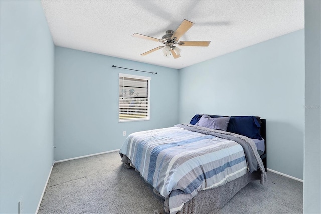 bedroom featuring ceiling fan, carpet floors, and a textured ceiling