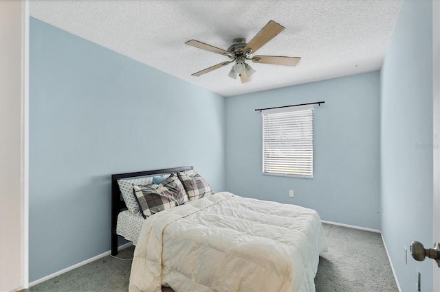 carpeted bedroom featuring a textured ceiling and ceiling fan