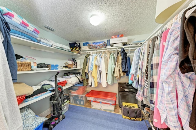 walk in closet featuring carpet flooring