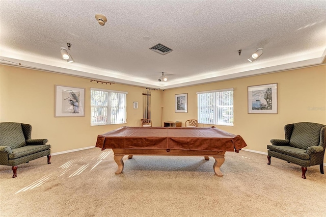 recreation room with light carpet, a tray ceiling, a wealth of natural light, and billiards