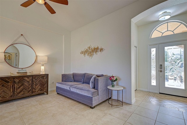 tiled entryway featuring ceiling fan and lofted ceiling