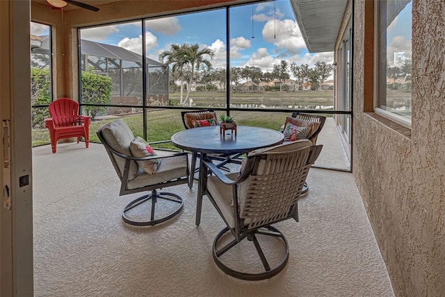 sunroom / solarium featuring ceiling fan