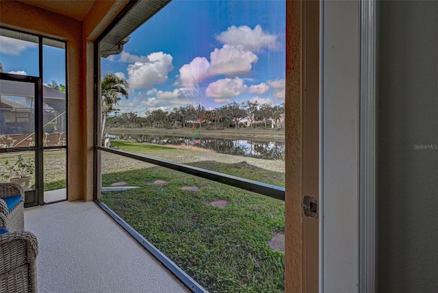 sunroom with a healthy amount of sunlight and a water view