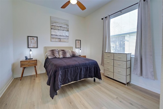 bedroom with multiple windows, ceiling fan, and light wood-type flooring