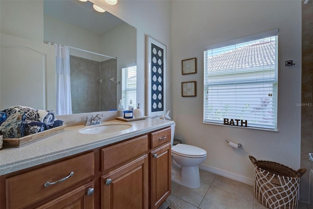 bathroom with toilet, tile patterned flooring, vanity, and walk in shower