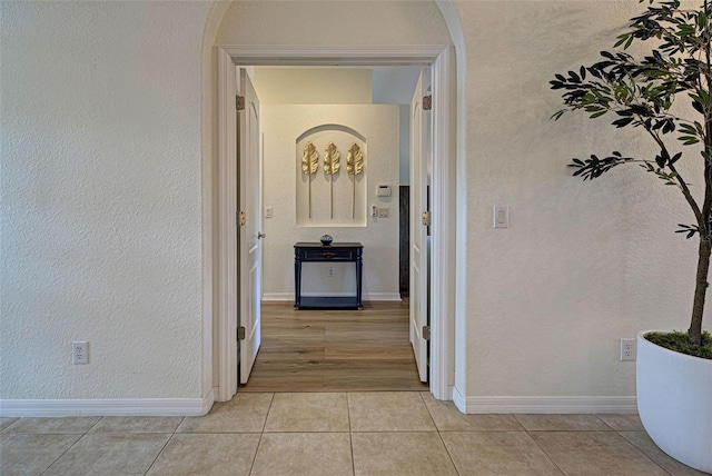 hall featuring light tile patterned floors