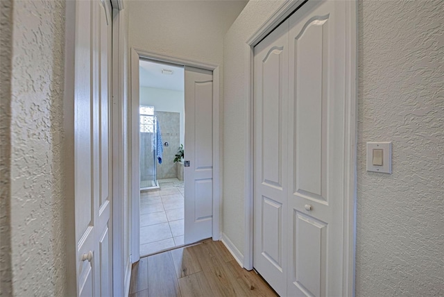 hall with light hardwood / wood-style floors