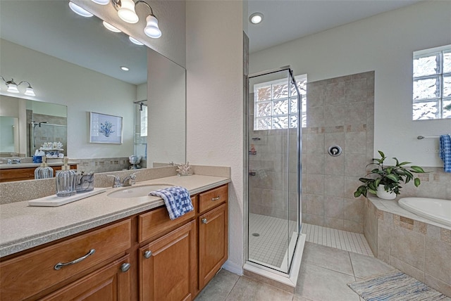 bathroom with vanity, tile patterned floors, and separate shower and tub