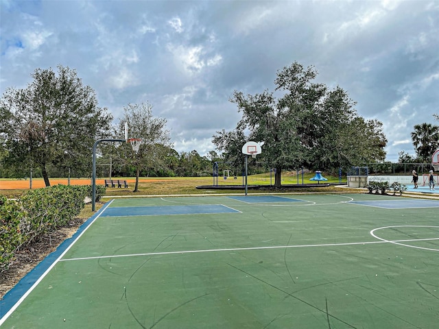 view of sport court featuring a playground