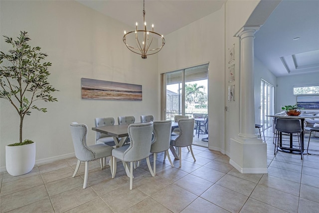 tiled dining room featuring a notable chandelier, a wealth of natural light, and ornate columns