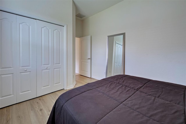 bedroom with a closet and light hardwood / wood-style flooring