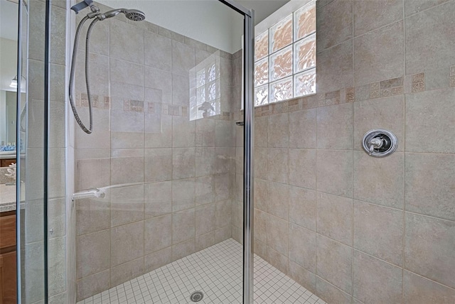 bathroom with a shower with door