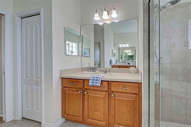 bathroom featuring tile patterned floors, an enclosed shower, and vanity