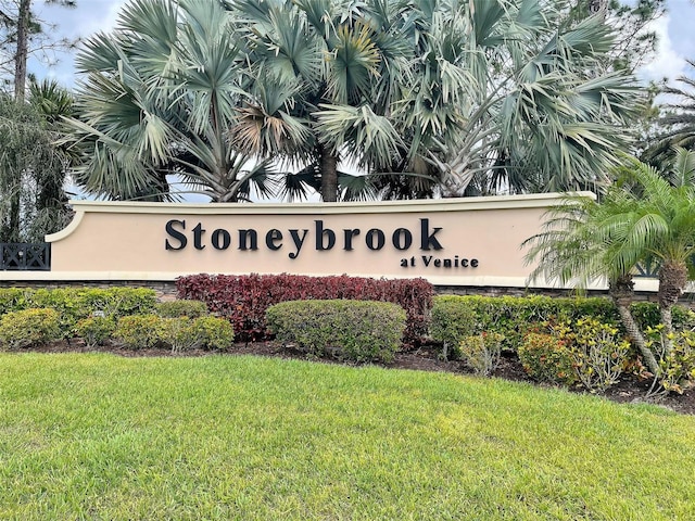 community / neighborhood sign with a lawn