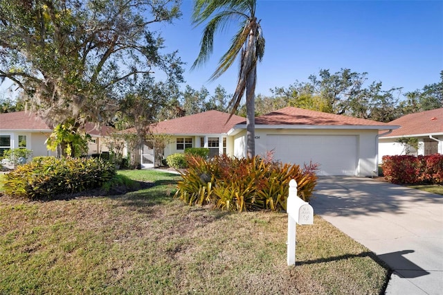 ranch-style home featuring a front yard and a garage