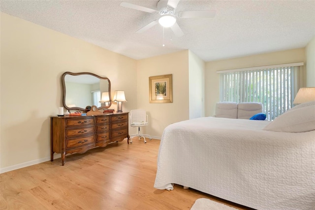 bedroom featuring a textured ceiling, light hardwood / wood-style flooring, and ceiling fan