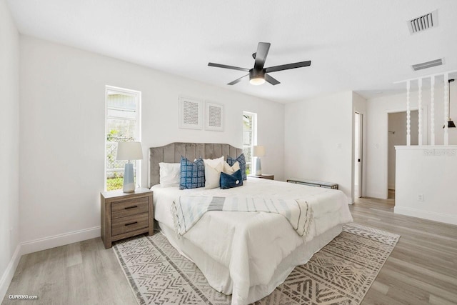 bedroom with ceiling fan and light hardwood / wood-style floors