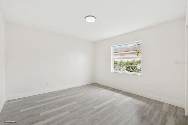 spare room with light hardwood / wood-style flooring