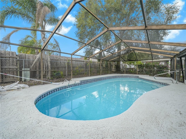 view of swimming pool with a lanai and a patio