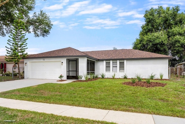 ranch-style house featuring a front lawn and a garage