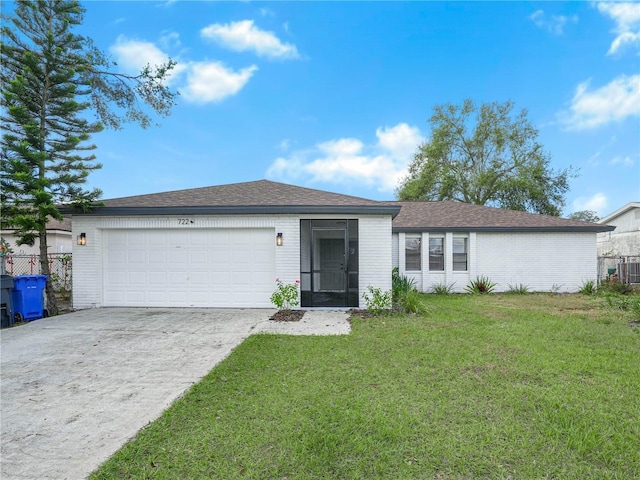 ranch-style house featuring a front yard and a garage