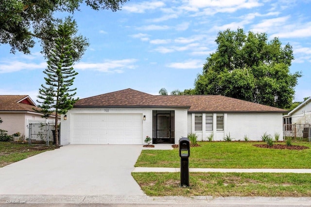 ranch-style house with a front yard and a garage