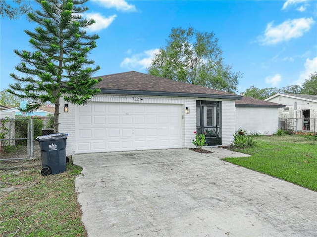 ranch-style home with a front lawn and a garage