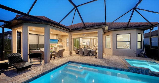 back house at dusk with a lanai, ceiling fan, a swimming pool with hot tub, and a patio area