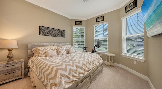 bedroom with light colored carpet, ornamental molding, and multiple windows