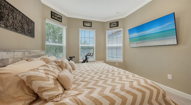 carpeted bedroom with ornamental molding