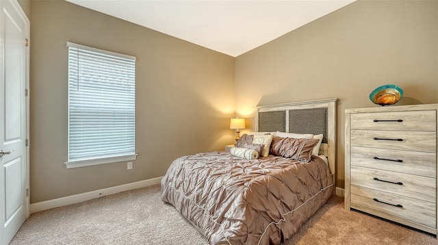 bedroom with light carpet, multiple windows, lofted ceiling, and baseboards