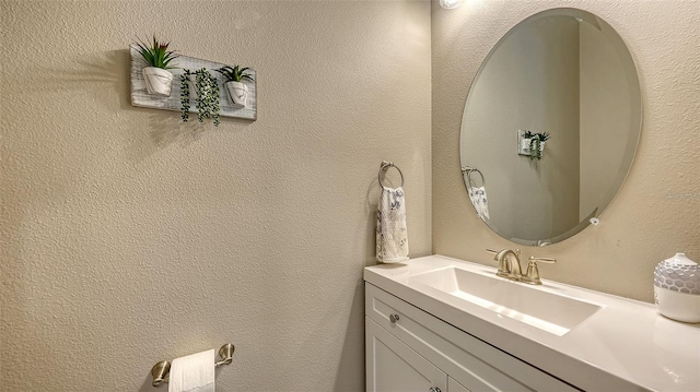 bathroom with vanity and a textured wall