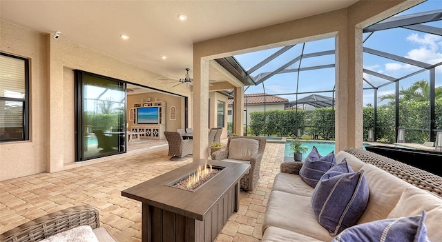 view of patio / terrace with glass enclosure and an outdoor living space with a fire pit