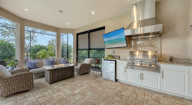 interior space featuring area for grilling, exterior kitchen, and a fire pit