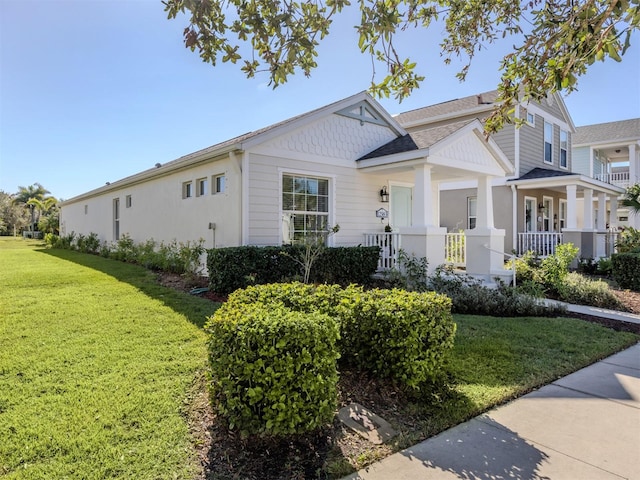 view of front of property featuring covered porch and a front yard