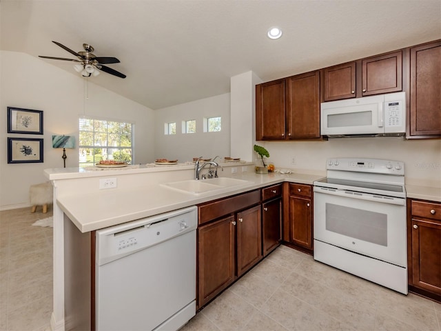 kitchen featuring ceiling fan, sink, kitchen peninsula, vaulted ceiling, and white appliances