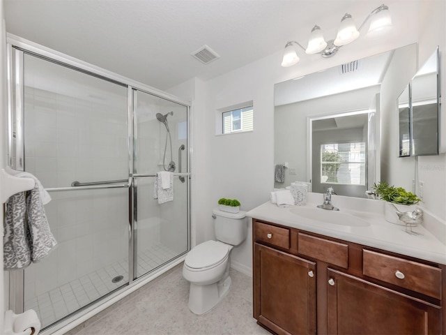 bathroom featuring vanity, toilet, and walk in shower