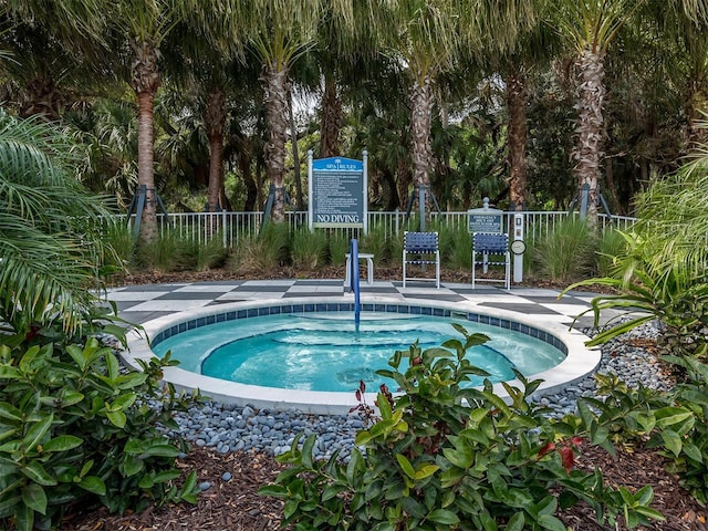 view of swimming pool with a hot tub