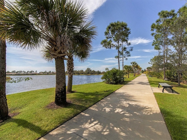 view of community featuring a yard and a water view